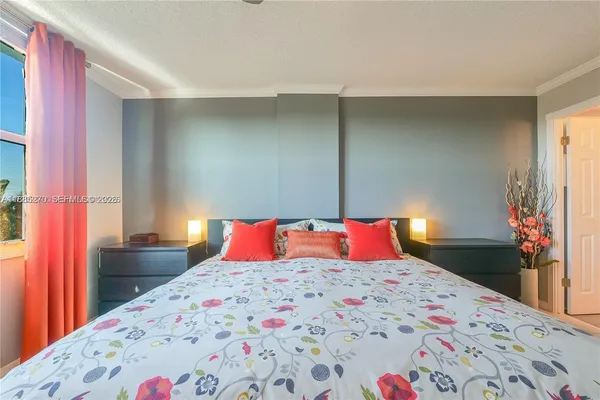 a bedroom with a bed and a dresser in it