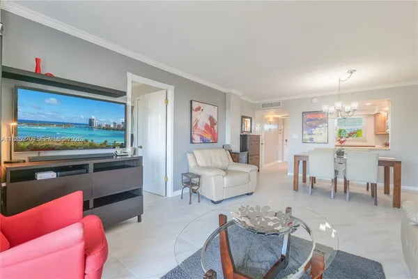 a living room with furniture kitchen view and a window