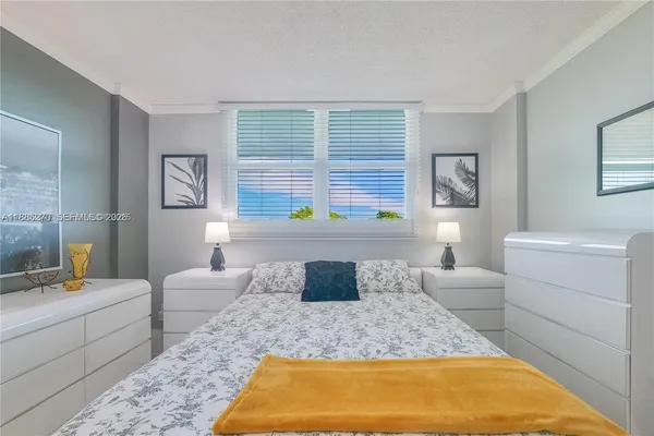 a bedroom with a large bed and a window