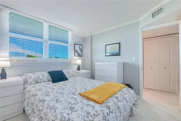a bedroom with a bed and a dresser