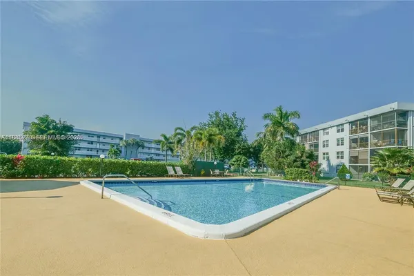 a view of a swimming pool with a yard