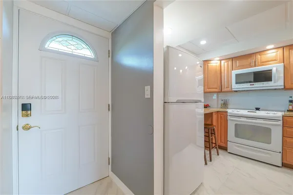 a kitchen with a stove microwave and sink with granite countertops