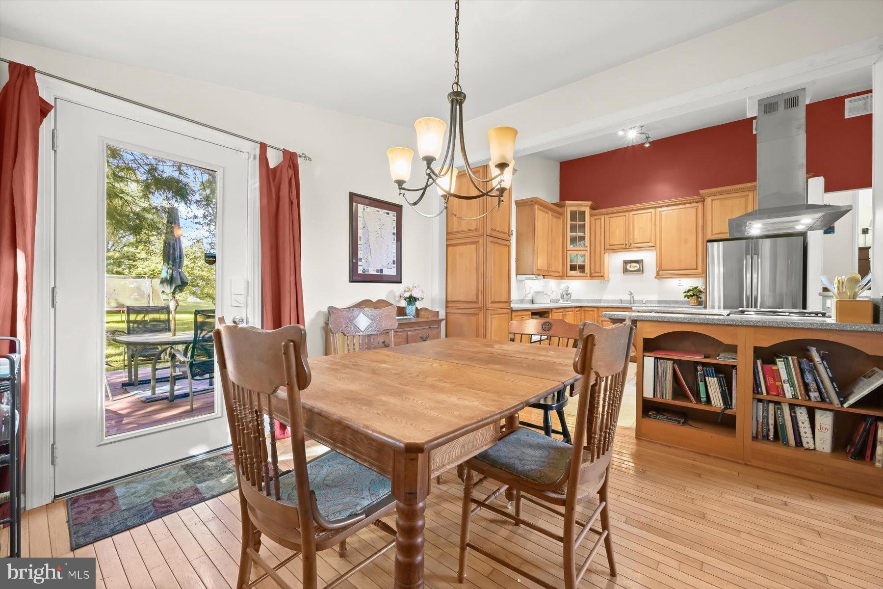 9233 Spring Valley Road Ellicott City, MD 21043 - Photo 12 of 45 a view of a dining room with furniture window and wooden floor