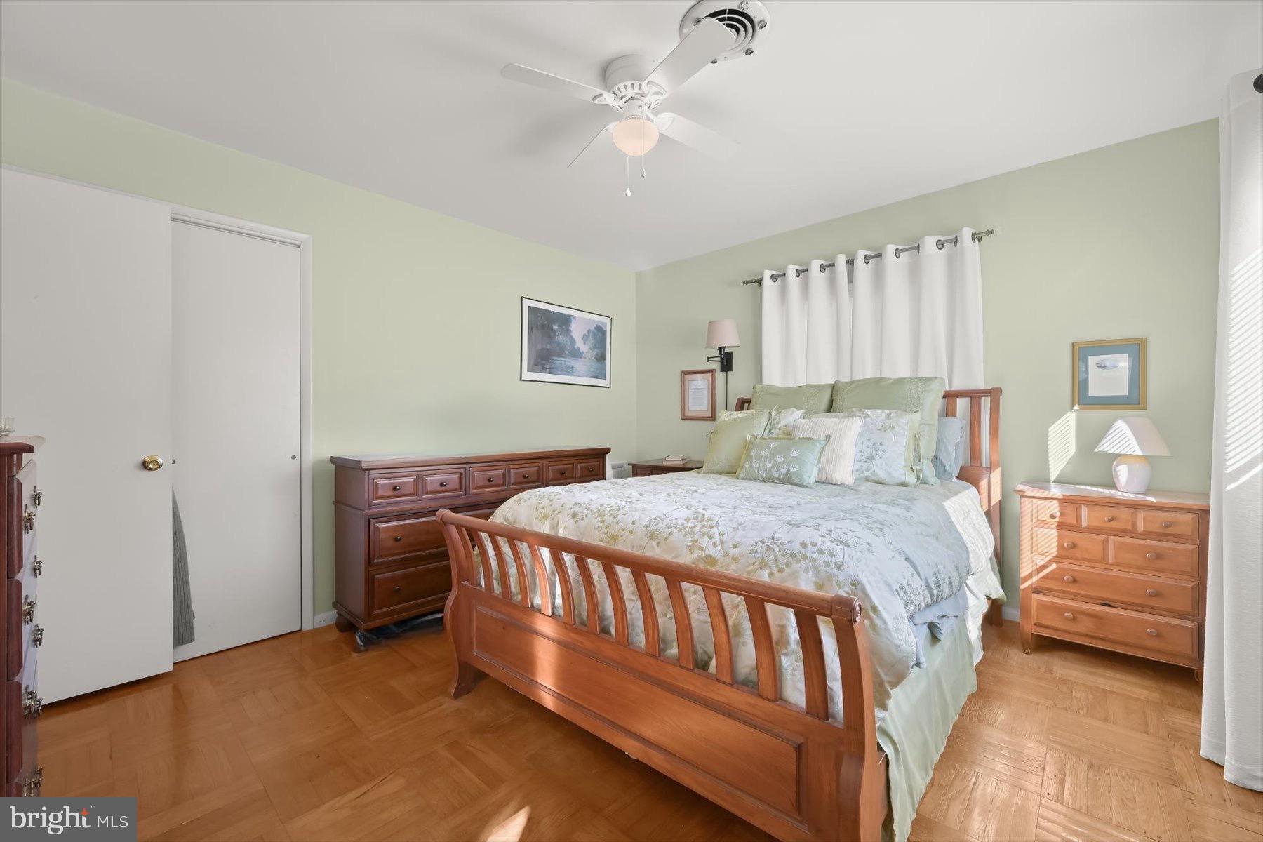 9233 Spring Valley Road Ellicott City, MD 21043 - Photo 16 of 45 a bedroom with a bed and a chandelier