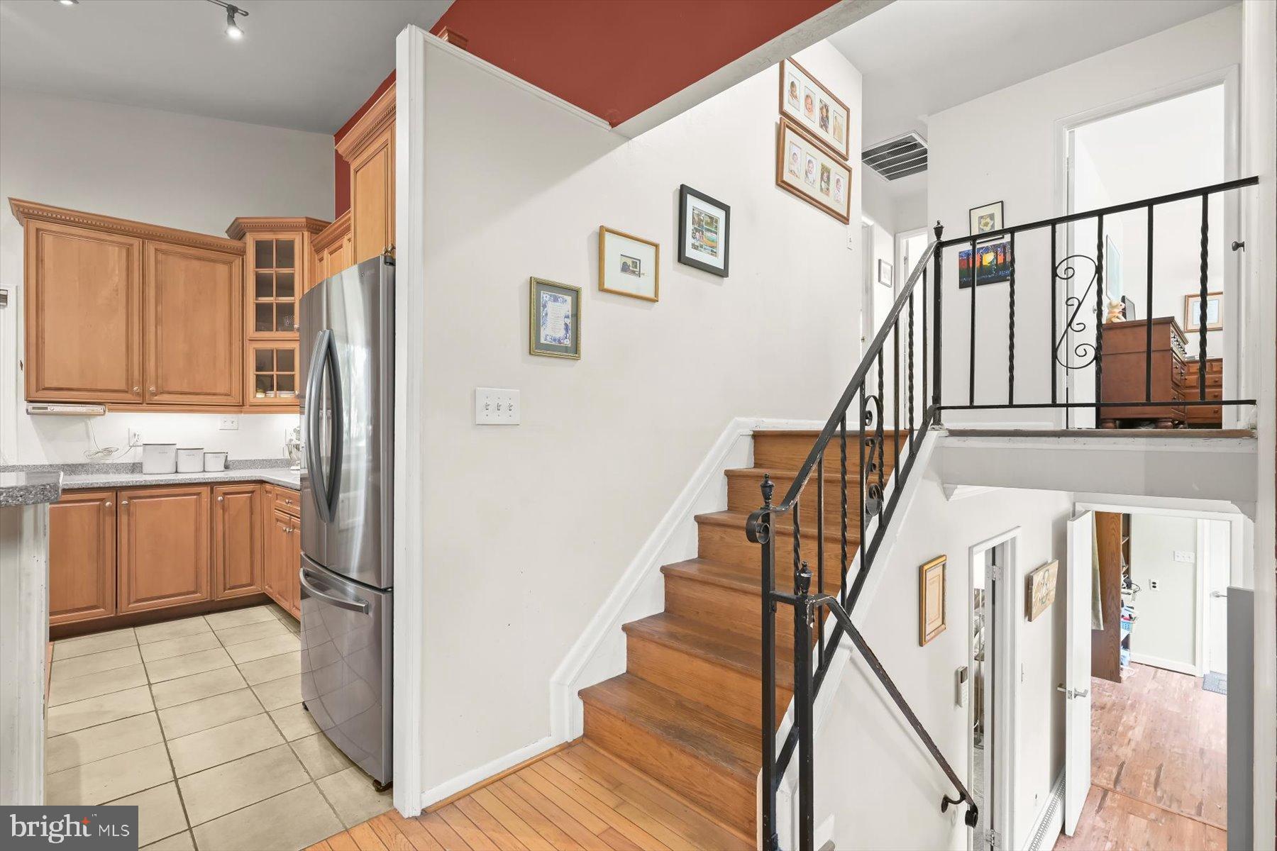 9233 Spring Valley Road Ellicott City, MD 21043 - Photo 24 of 45 a view of an entryway with wooden floor and stairs