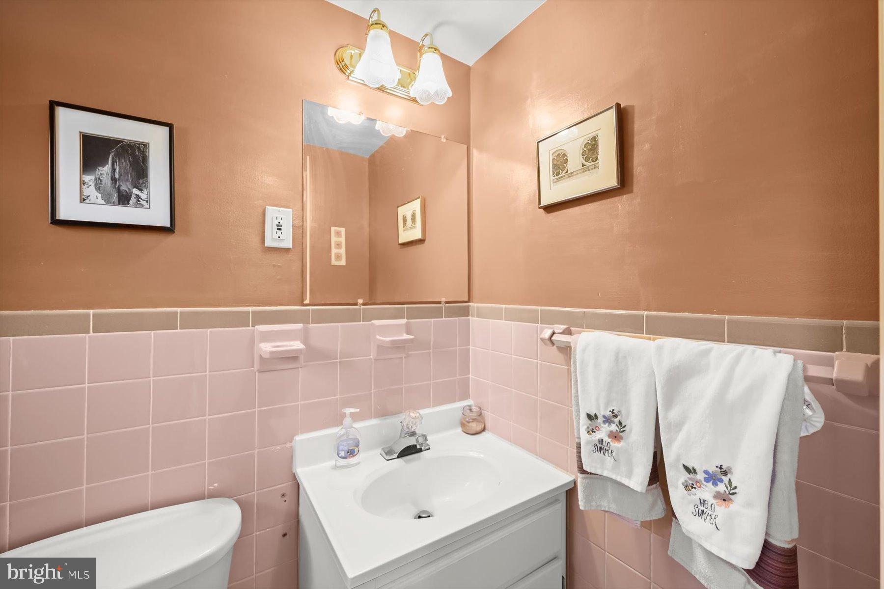 9233 Spring Valley Road Ellicott City, MD 21043 - Photo 30 of 45 a bathroom with a sink mirror and toilet