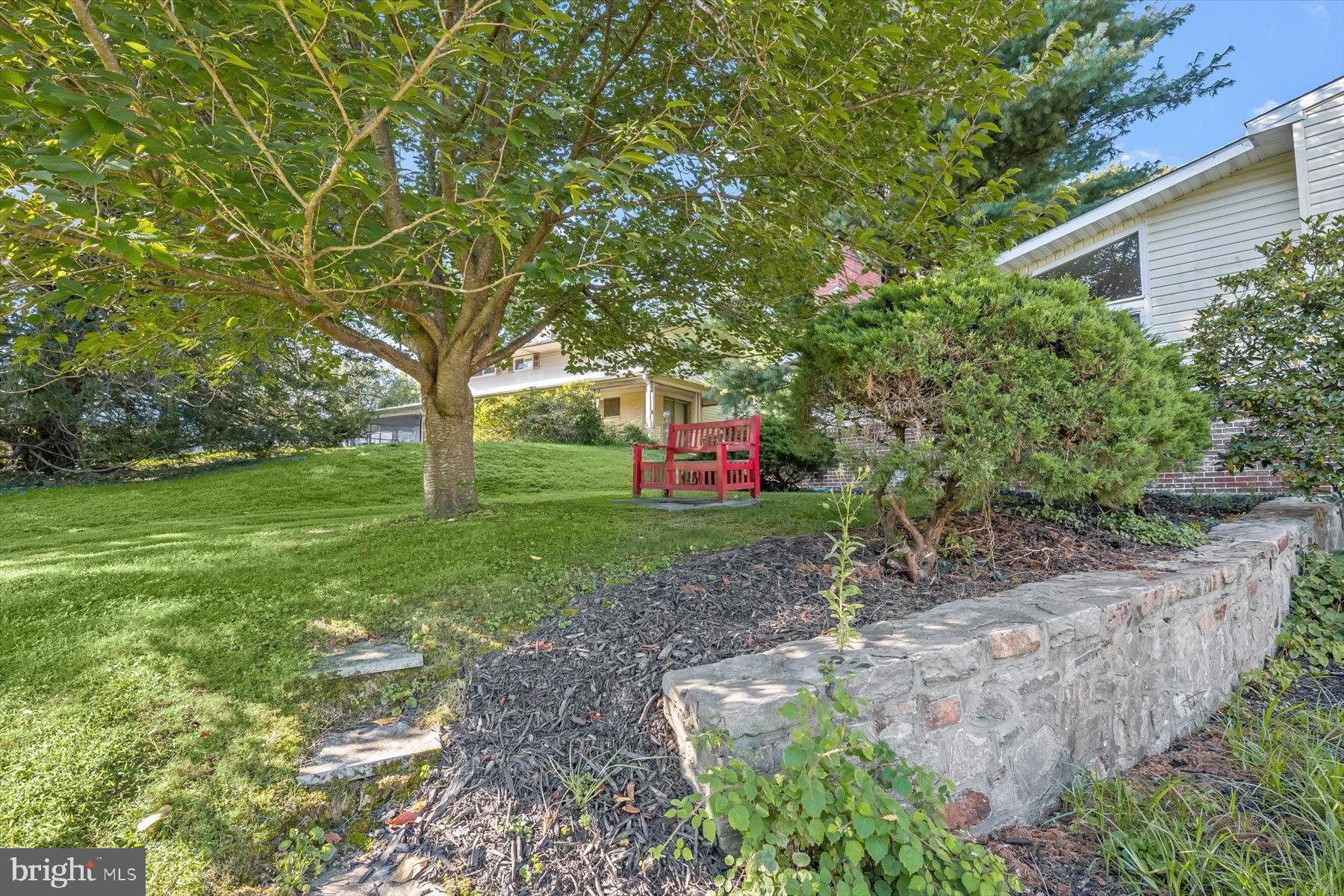 9233 Spring Valley Road Ellicott City, MD 21043 - Photo 42 of 45 a small garden covered with tall trees
