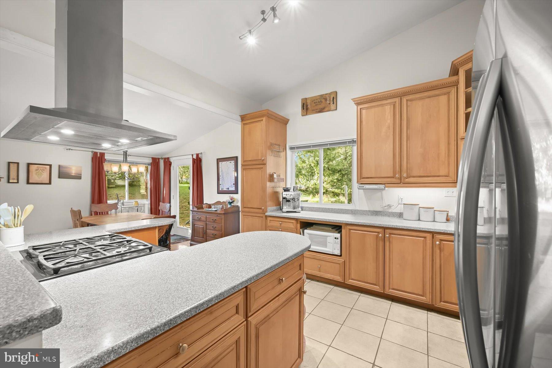 9233 Spring Valley Road Ellicott City, MD 21043 - Photo 6 of 45 a kitchen with stainless steel appliances granite countertop a stove a sink and a refrigerator