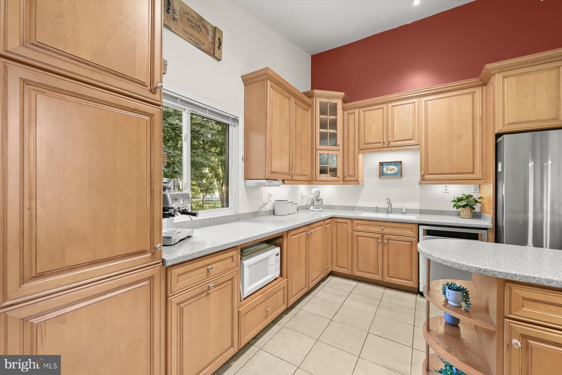 9233 Spring Valley Road Ellicott City, MD 21043 - Photo 9 of 45 a kitchen with stainless steel appliances granite countertop a refrigerator and a sink