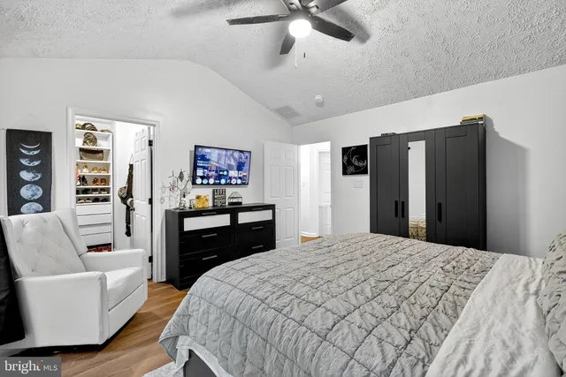 a bedroom with a bed and a couch