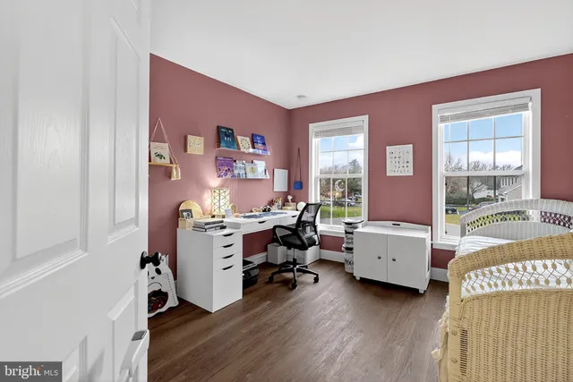 a view of a livingroom with workspace and a window
