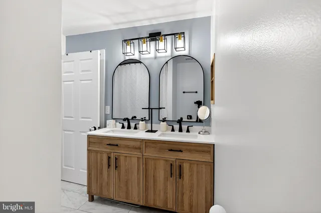a bathroom with 2 sink and a mirror