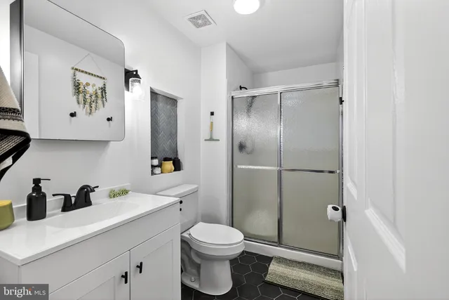 a bathroom with a toilet sink and shower