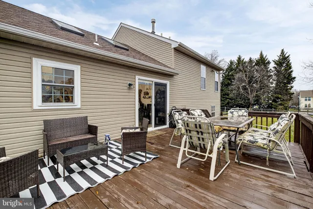 a view of a patio with table and chairs with wooden floor and fence