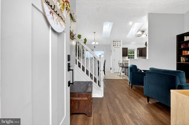 a view of entryway and hall with wooden floor