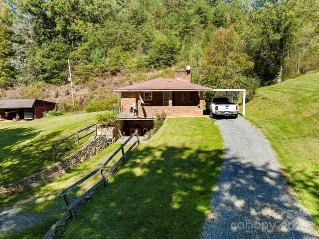 a view of a patio with table and chairs under an umbrella