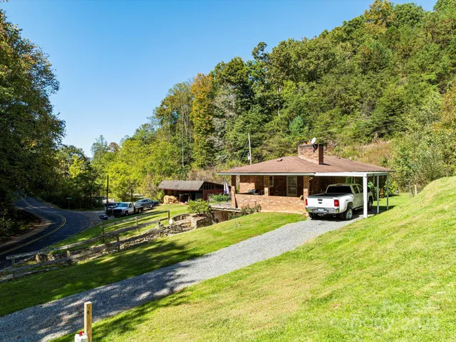 a view of a house with swimming pool and yard