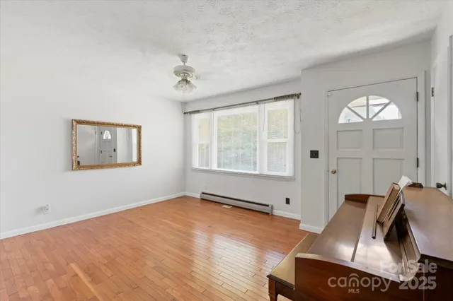 a view of room with window and ceiling fan