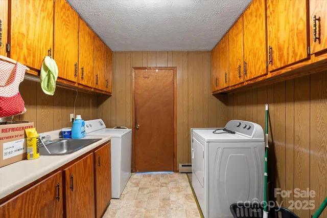 a utility room with sink dryer and washer