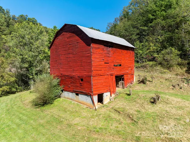 a backyard of a house with large trees and brick walls