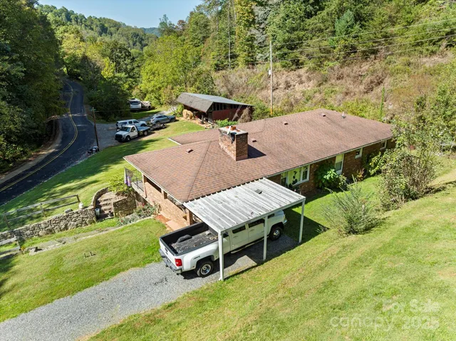 an aerial view of a house with swimming pool garden and patio