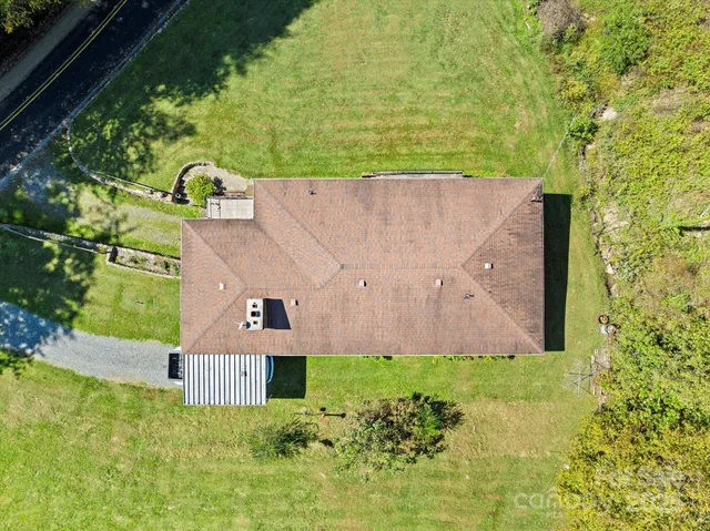 an aerial view of a house with a yard