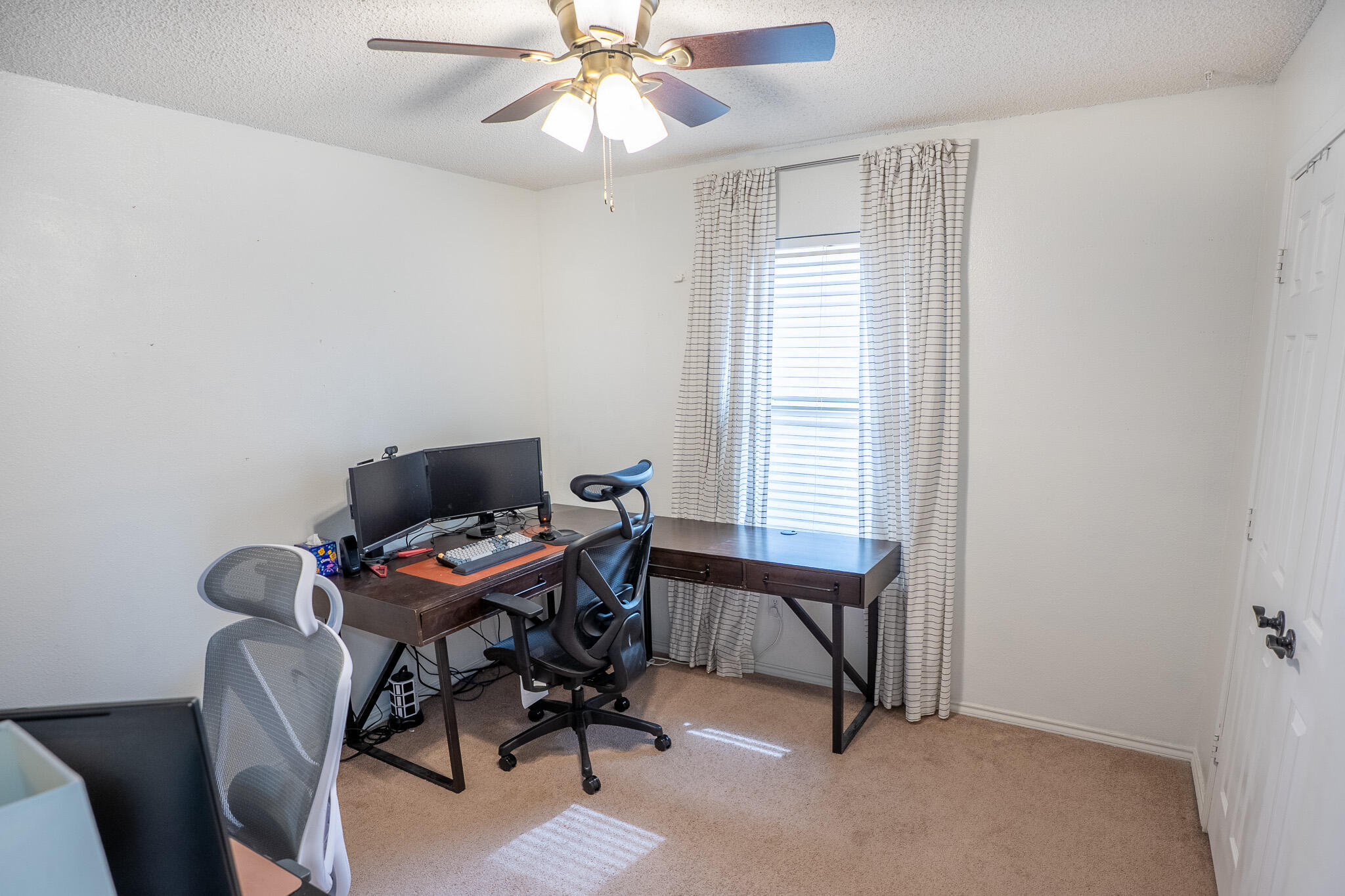 1609 78th Street Lubbock, TX 79423 - Photo 22 of 36 a view of a workspace with furniture and a window