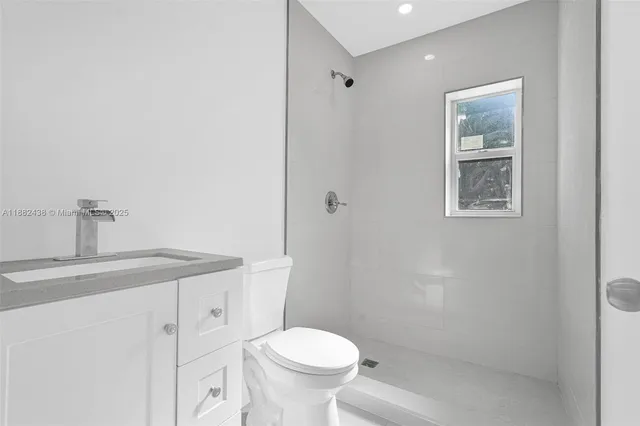 a white toilet sitting next to a bathroom sink