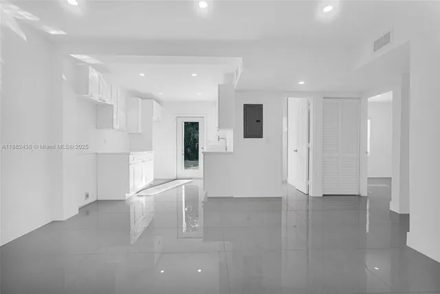 a view of kitchen with furniture and refrigerator