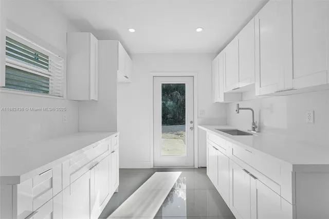 a kitchen with white cabinets