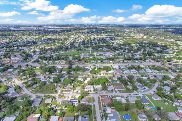 an aerial view of residential houses with city view