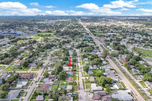 an aerial view of residential houses with city view