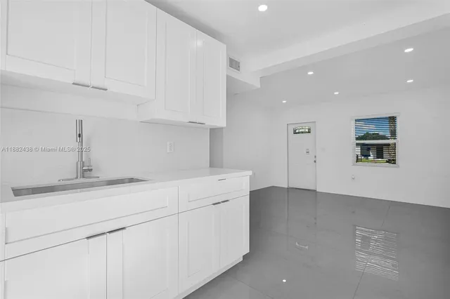 a kitchen with white cabinets