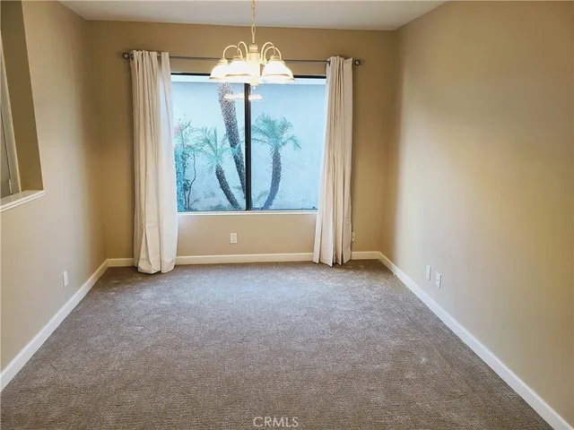 an empty room with closet and wooden door