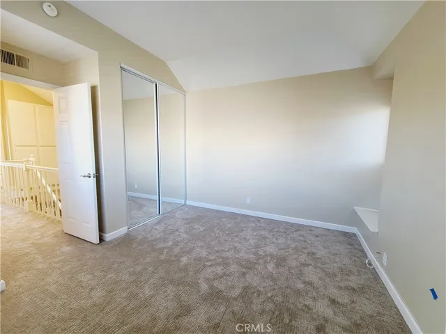 a view of a lush green field with mountains in the background