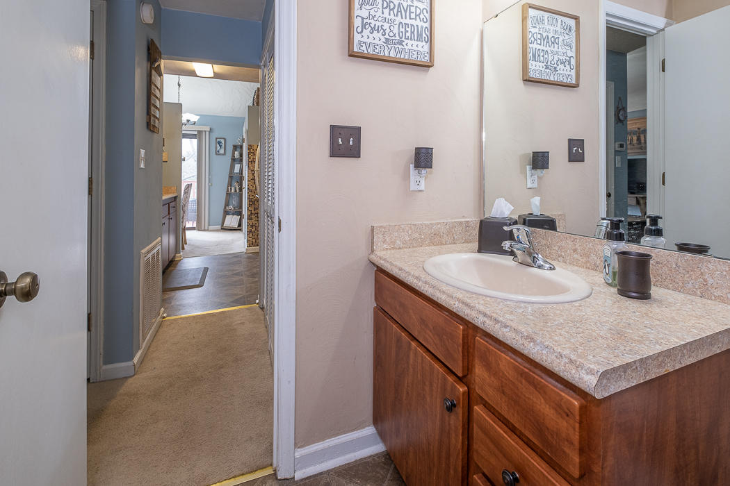 3327 Forest Ridge Road Roanoke, VA 24018 - Photo 19 of 31 a en suite bathroom with a granite countertop sink and a mirror