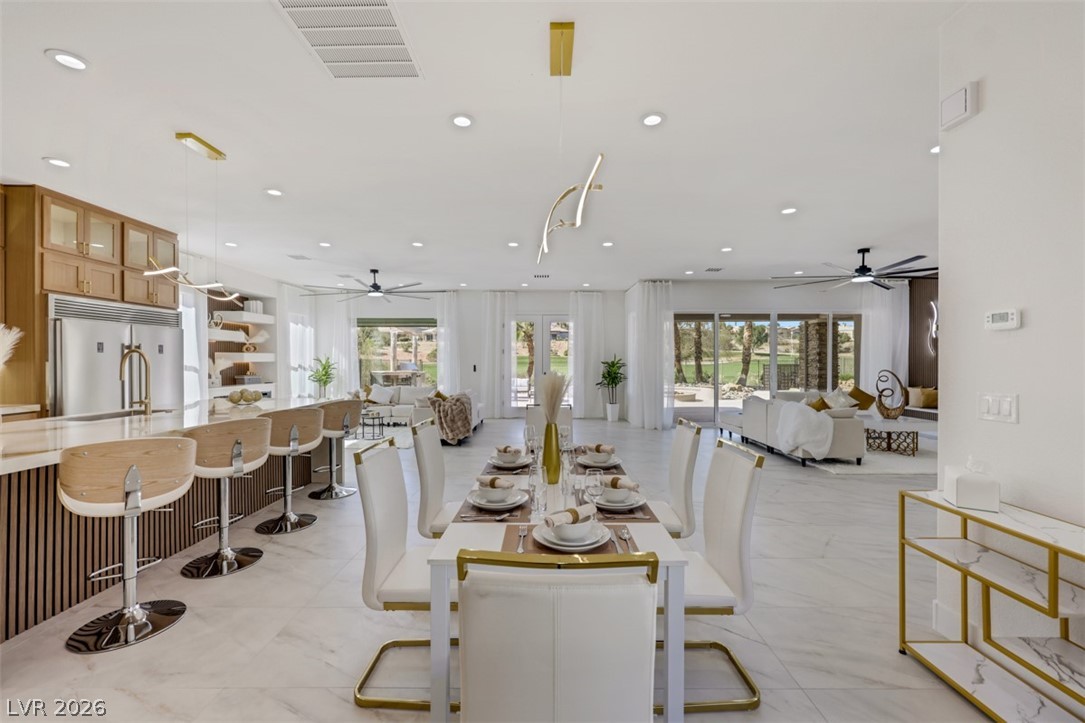 5015 Rivedro Street Las Vegas, NV 89135 - Photo 17 of 91 Seamlessly blending kitchen, dining, and living areas for harmonious entertaining, this open-concept home is perfect for social gatherings.