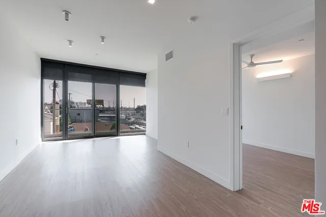 a view of a room with wooden floor