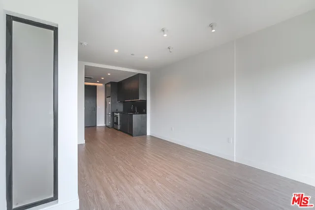 a view of a kitchen with a sink and a refrigerator