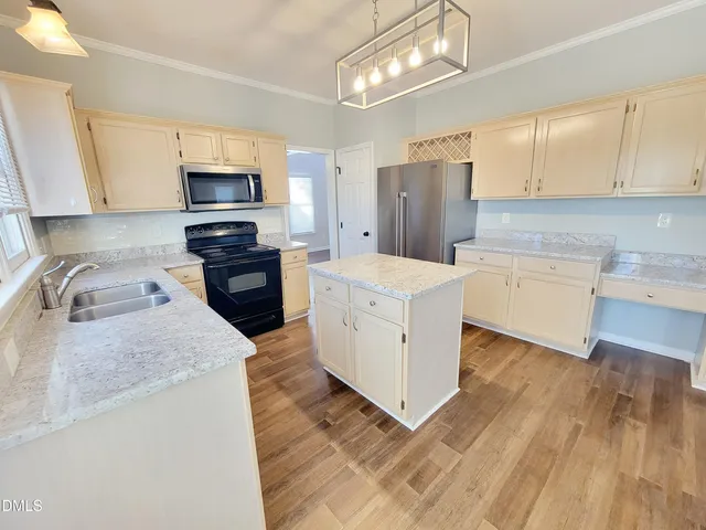 a view of empty room with wooden floor and windows
