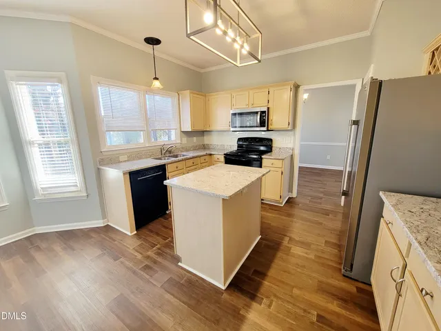 a view of an empty room with a fireplace and a window