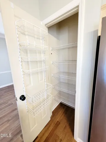 a view of a living room with wooden floor