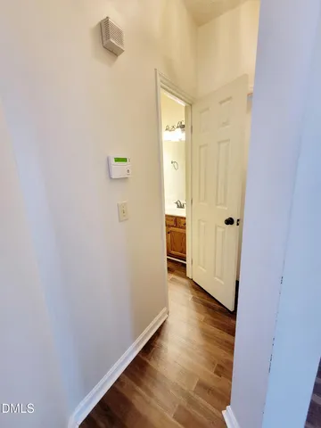 a view of an empty room with a chandelier fan