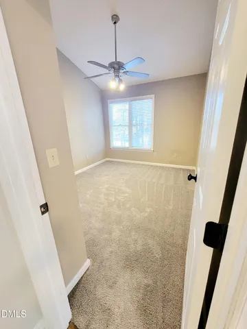 a view of a kitchen with furniture and a refrigerator