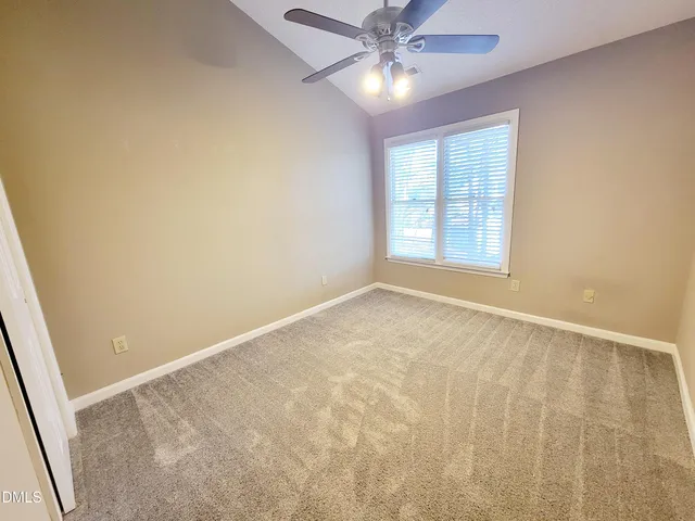 a view of a balcony with wooden floor and fence