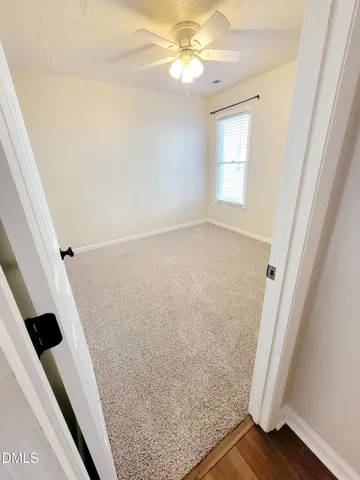 a front view of a house with a yard covered in snow