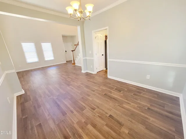 a large kitchen with stainless steel appliances granite countertop a sink a stove and wooden floor