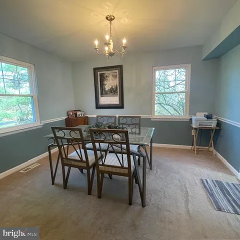 a view of a dining room with furniture and window