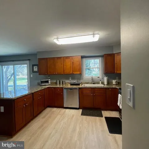 a kitchen with stainless steel appliances granite countertop a stove a sink and a refrigerator