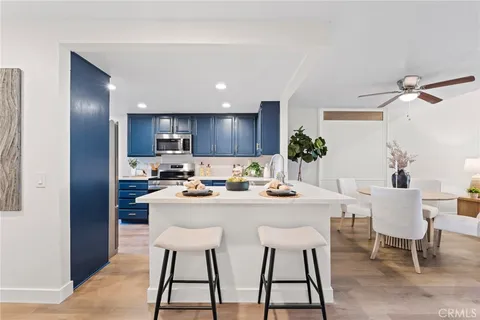 a kitchen with stainless steel appliances granite countertop wooden cabinets a stove top oven a sink and dishwasher